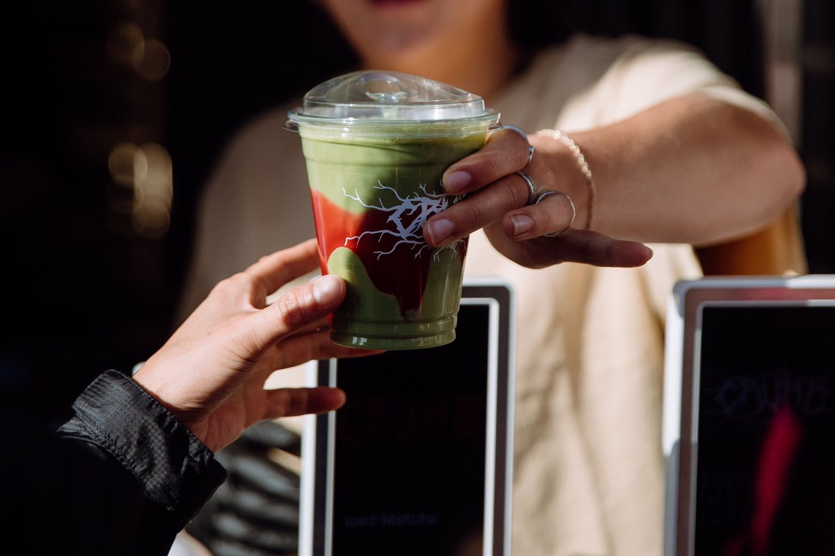 CRUMB iced matcha handed over the counter