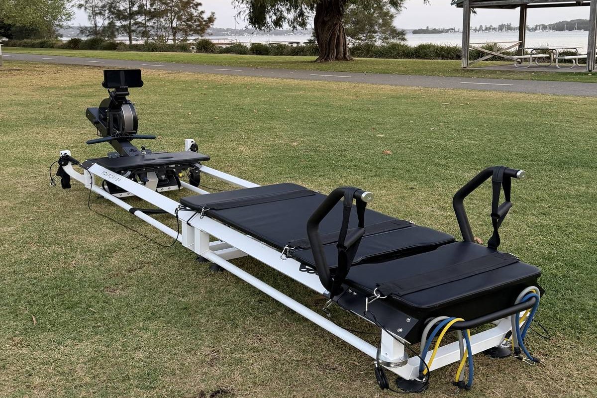 STRONG reformer on the grass at Speers Point Park, Lake Macquarie behind