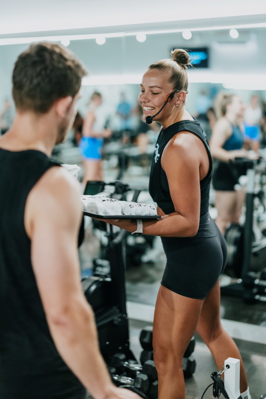 A STRONG trainer handing out refreshments mid-class